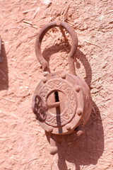 old rusty ancient arabian lock hanging in the wall