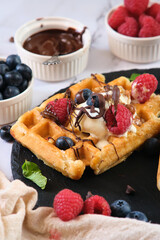 still life Belgian waffles on a black round plate