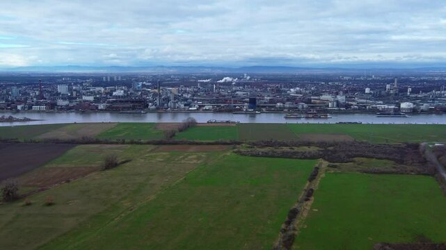 Ships leaving river port of large chemical industry Complex loaded with cargo, Drone wide dolly in