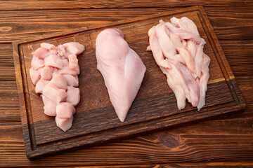 Fototapeta premium Raw chicken meat fillet ( breast ) Various of cutting in form slice and cube . Top view