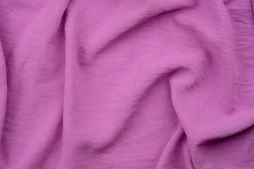 Soft purple fabric draped elegantly on a flat surface in natural light during daytime