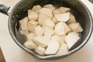 Taro being cooked, peeled and lye removed