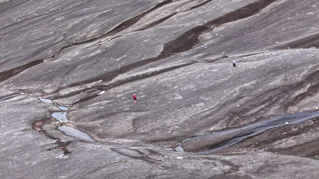 People hiking in the rock formations of Verdenssvaet in northern Norway (Narvik)