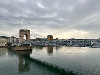Fototapeta premium La Passerelle suspension bridge over the river Rhône in Vienne, Auvergne-Rhône-Alpes, France, June 2023