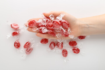 A pile of red candies in hand.