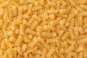 Spiral pasta background. Light wheat fusilli.