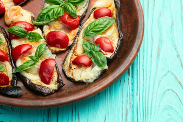 Italian mini pizza . Aubergine (eggplant ) with mozzarella cheese and basil . On rustic background