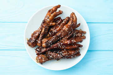 Caramelized korean or Chinese chicken foots ( paws ) with sesame . Top view