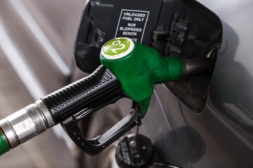 The gas station. Filling the car with gasoline. A Russian fuel dispenser in the fuel tank of a car at a gas station. Rising fuel prices around the world.