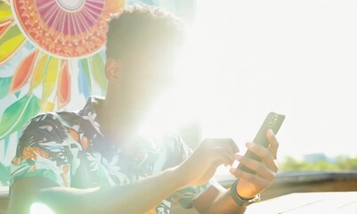 Haitian Man Shopping Online and Comparing Prices - Powered by Adobe