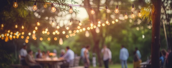 blurry garden wedding background decorated with fairy lights in summer