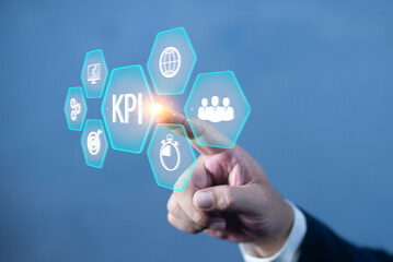 KPI Key Performance Indicator for Business Concept. Businessman working with data to analyze key performance indicators (KPI) displayed as holographic icons