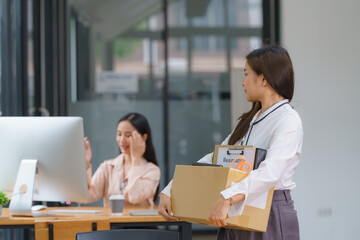 Obraz premium Unemployed, quiet job, desperate Asian young businesswoman resigning from company packing belongings, stuff in box cardboard, layoff or leaving, changing work. Resignation employment, dismiss concept.