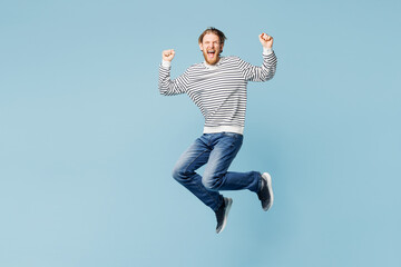 Full body young excited surprised happy man he wear striped sweatshirt casual clothes jump high do...