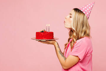 Side profile view young happy shocked surprised woman wear shirt cone hat celebrating birthday...