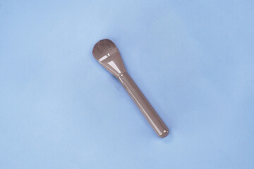 makeup brush on blue background