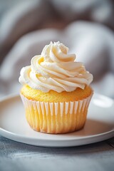 Cupcake with icing on a white plate