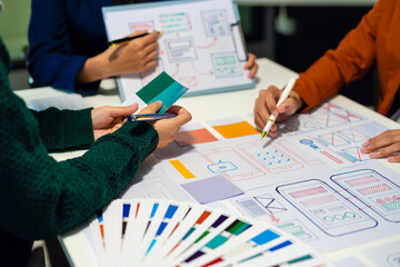 UX developer and ui designer brainstorming about mobile app interface wireframe design with...
