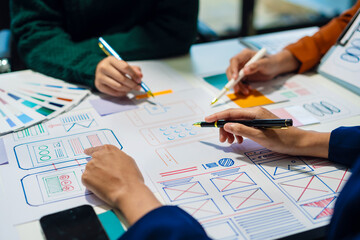 UX developer and ui designer brainstorming about mobile app interface wireframe design with...