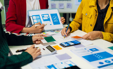 UX developer and ui designer brainstorming about mobile app interface wireframe design with...