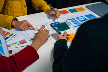 UX developer and ui designer brainstorming about mobile app interface wireframe design with...