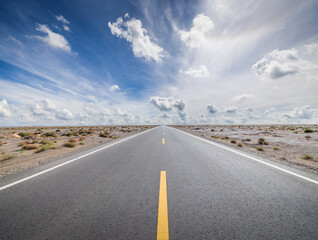 Asphalt highway road and desert natural landscape under the blue sky. Car background.