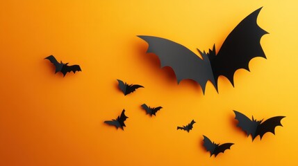 Black paper bats on a bright orange background.