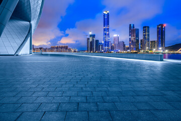 Empty square floors and city skyline with modern buildings scenery at night. car advertising...