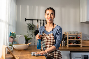 Portrait Asian cleaning service woman worker cleaning kitchen at home. 