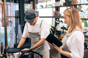 Asian attractive male barista or waiter working in coffeehouse shop. 