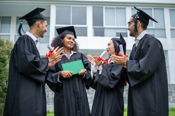 Group of diverse students celebrating college achievement outside campus. 