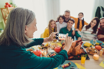 Photo of positive cheerful family celebrating thanksgiving day woman photographing friendly family...