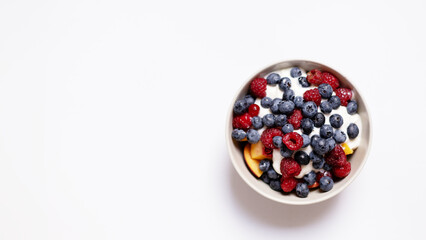 a bowl of fruits in white background. with a place for lettering. organic food for people. healthy lifestyle