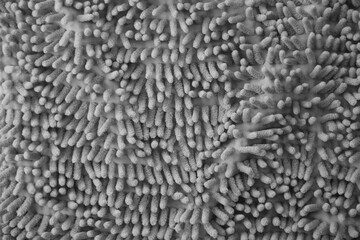Processed image of fluffy gray doormat from bathroom in grey color