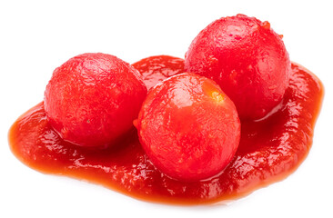 Peeled cherry tomatoes in tomato sauce or ketchup puddle close-up on a white background.