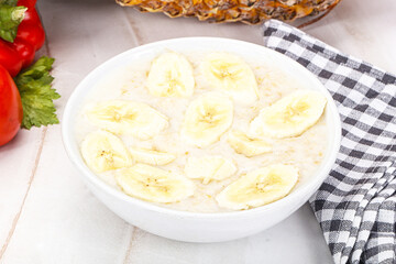 Sweet porridge with banana breakfast