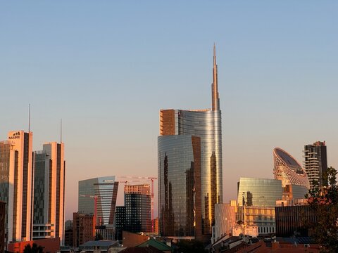 Milan, Italy - September 15, 2024: architectural skyline of Piazza Gae Aulenti during sunset.