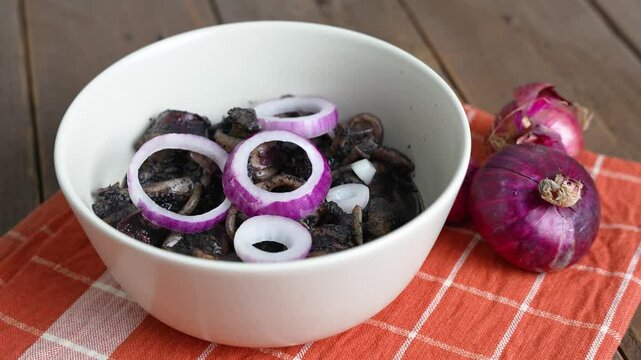 a tasty Filipino squid dish that uses Adobo method, also known as adobong pusit with a hint of spiciness topped with fresh red onions