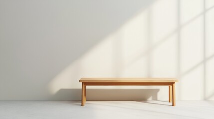 Minimalist wooden bench in bright room with natural light shadows on the wall.