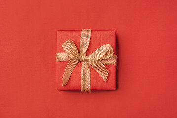 Gift boxe with bow on a red backdrop.