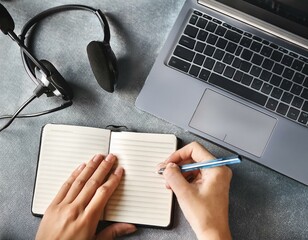 Female hands working on wooden work place with modern gadgets 