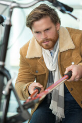 man using bolt croppers on bike lock