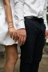 bride and groom holding hands