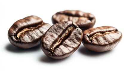 Naklejka premium Closeup of four roasted coffee beans with a white background.