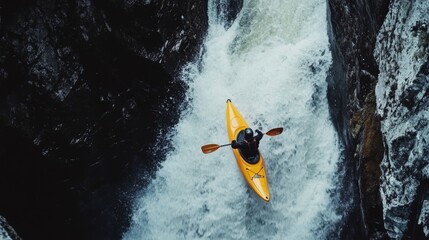 A kayaker navigates a thrilling waterfall, showcasing adventure and the beauty of nature from a breathtaking aerial perspective.