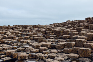Basalt columns at Giant's Causeway in Northern Ireland, formed by ancient volcanic activity,...