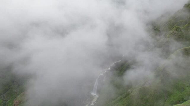 The charm of the beauty of a tropical valley at the foot of Mount Rinjani is so amazing, with a small waterfall, and mist that adorns the sky. indonesia mountain in asia