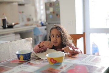 little girl has breakfast at home