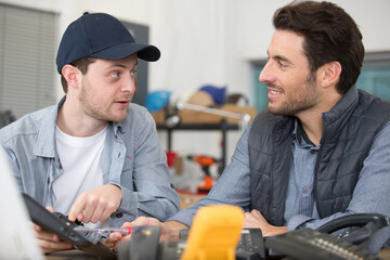 two male engineers in discussion in electronics workshop
