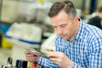 man using a magnifying in printing